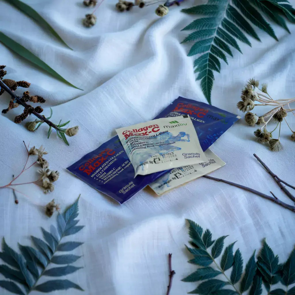 Maxiliv Collagen Max C sachets on a backdrop of leaves and fabric for joint support supplement
