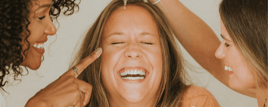 Women enjoying a playful moment together while discussing why retinol stops working after menopause.