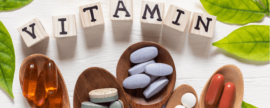 Essential Vitamin Guide with various vitamin supplements and leafy background.