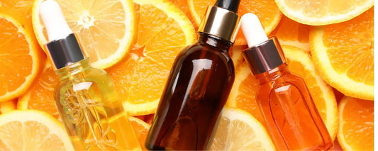 Bottles of vitamin C serum on orange slices, representing the Best Vitamin C Serum for UAE's climate.