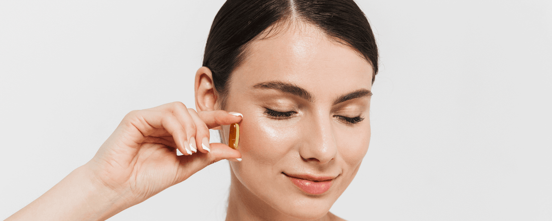 Woman holding a supplement, promoting herbs and supplements to slow aging for better skin health.
