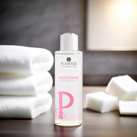 Rose water toner by Plantus Cosmetic on a wooden table with cotton pads and towels for skincare.