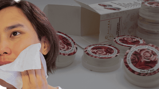 Person using Makeup Cleansing Wipes to remove makeup with product containers visible in the background.