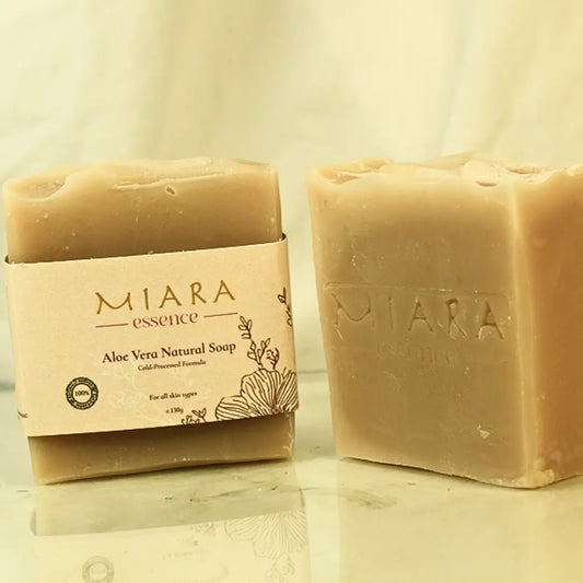 Two bars of MIARA Essence Aloe Vera Natural Soap on a reflective surface with a neutral background