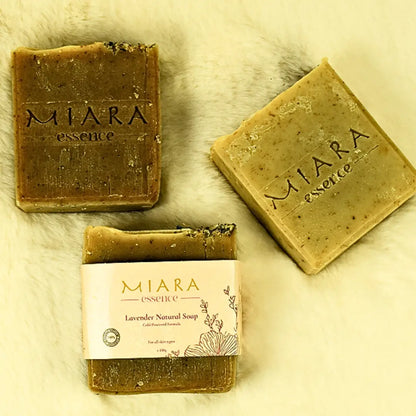 Three bars of Miara Essence Lavender Natural soap on a textured surface